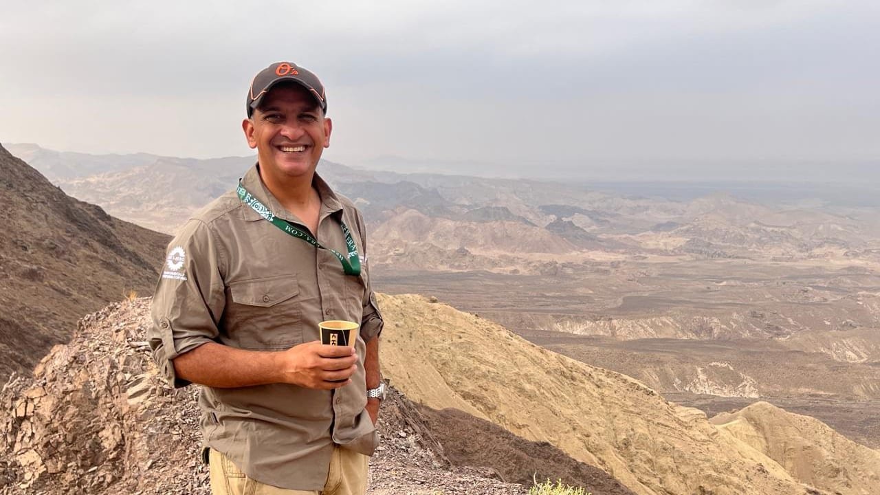 Professor Khan on a desert ridge during expedition medical cover