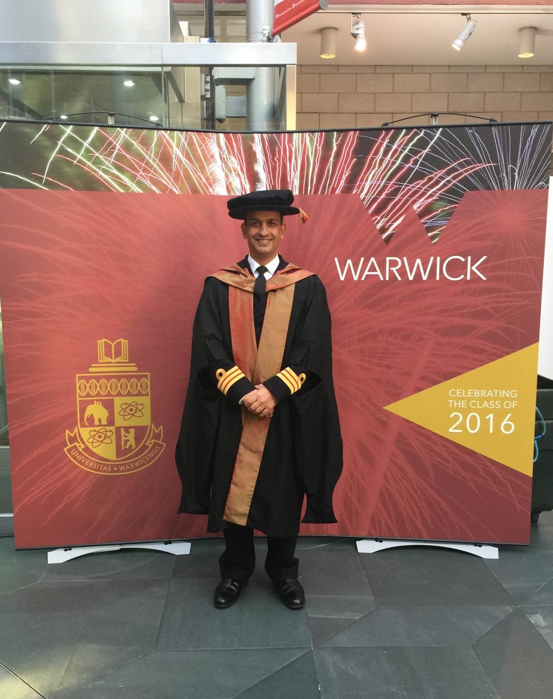 Doctoral graduation at the University of Warwick — robes over naval uniform